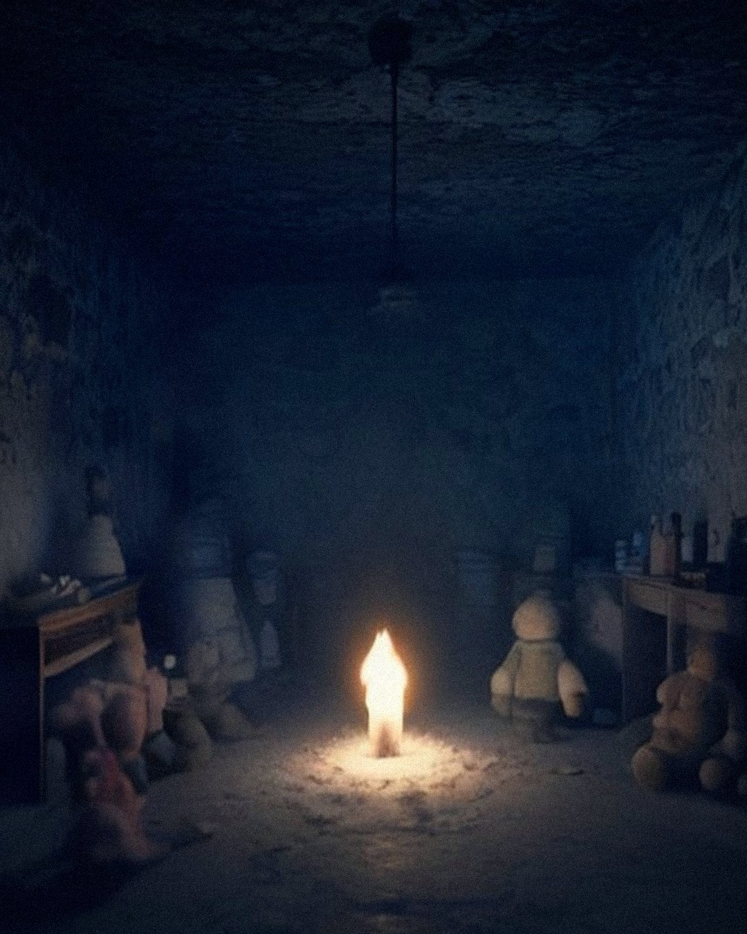 Candle burning among old dolls and toys left for Annie in a dark stone room of Mary King's Close, Edinburgh